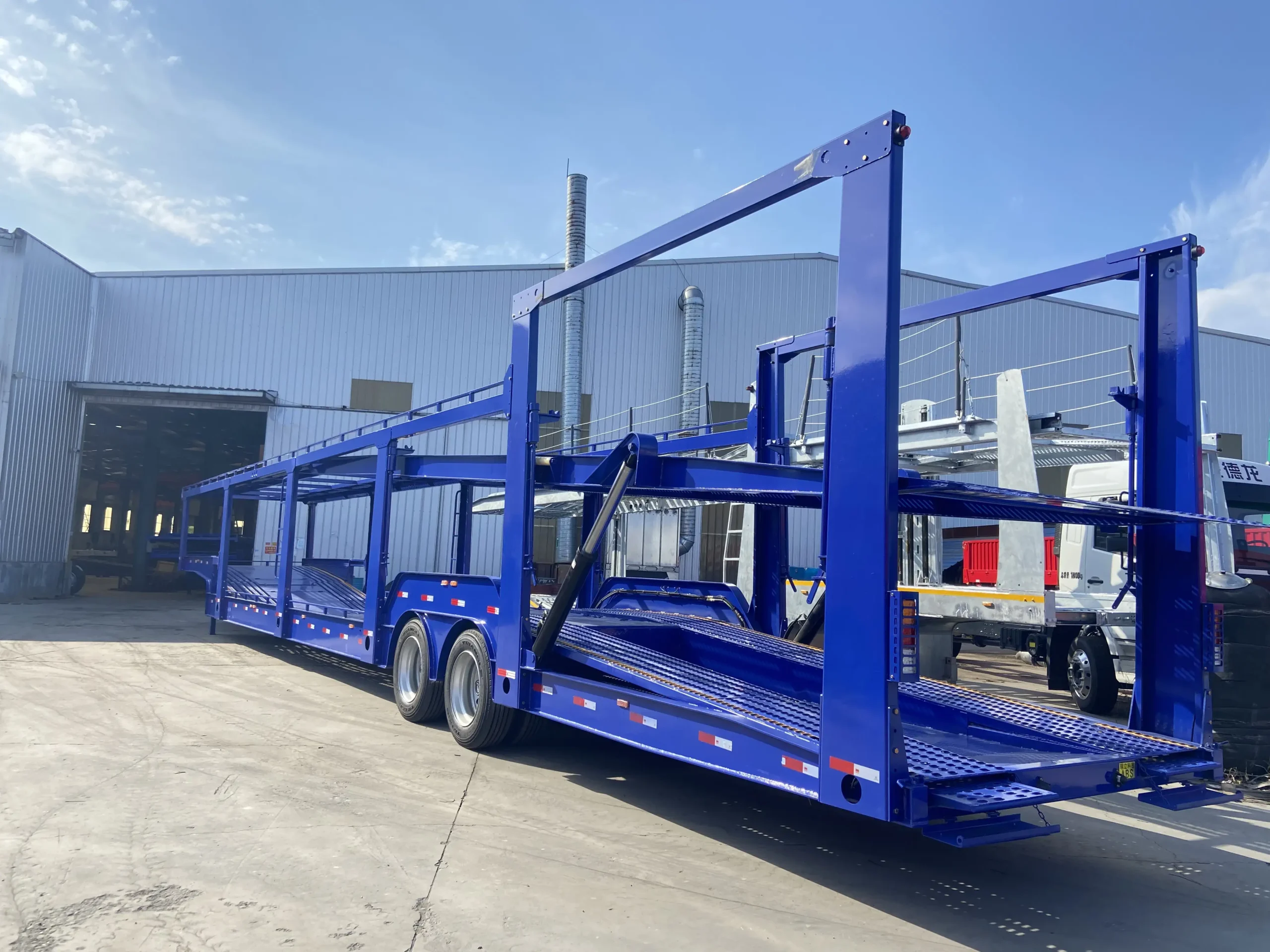 Perforated wheel tracks on car carrier trailer