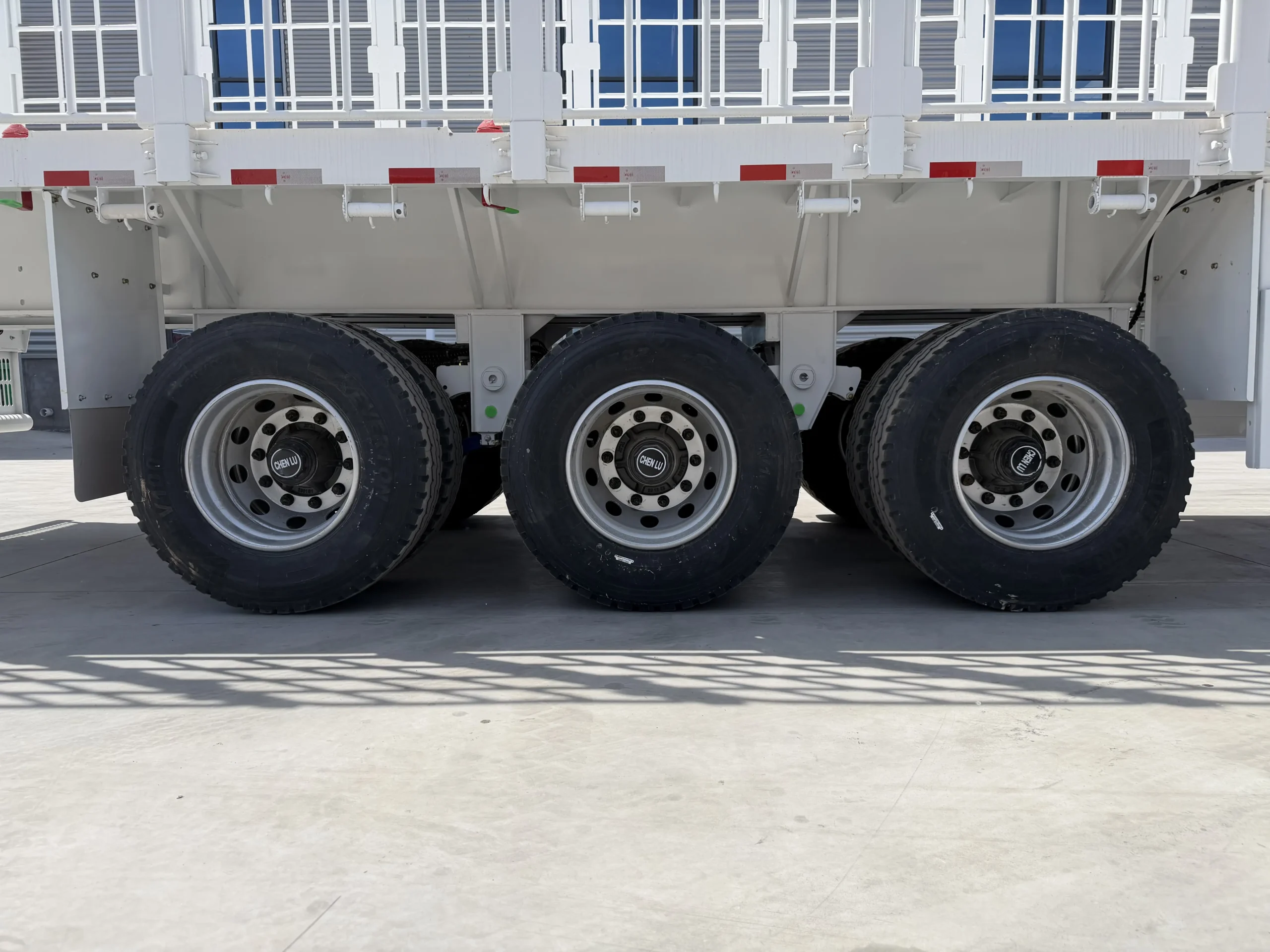 Tire and running gear detail of the three-axle fence cargo semi trailer