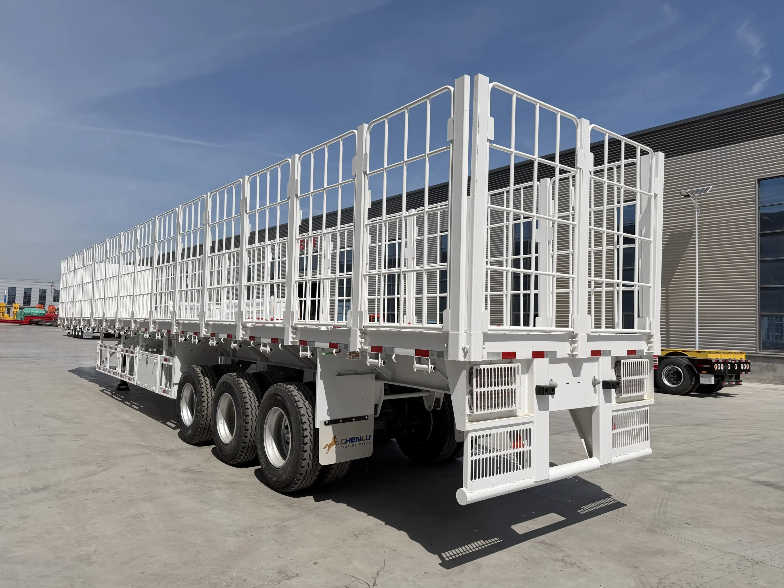 Right-side view of the three-axle fence cargo semi trailer
