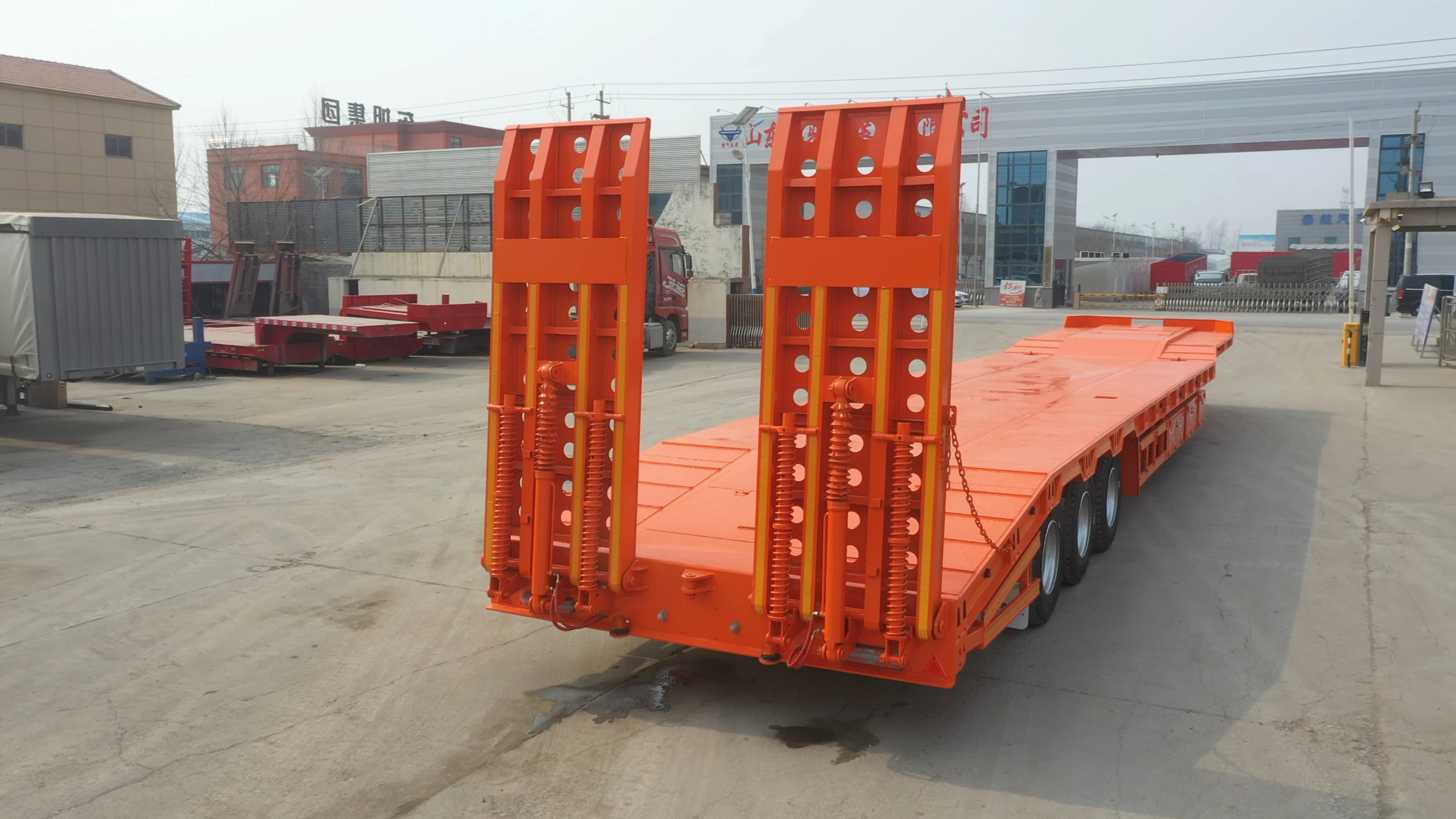 Side view of the three-axle lowbed semi trailer