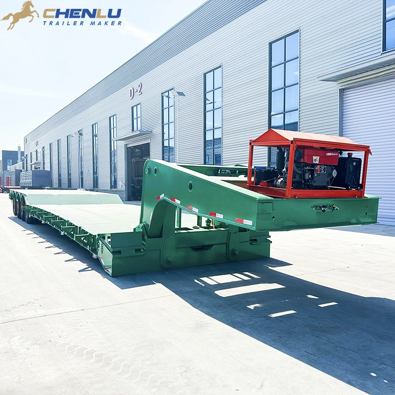 Green detachable gooseneck trailer viewed from the front corner with its low deck visible