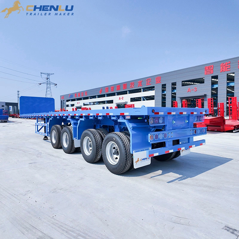 Blue four-axle flatbed trailer showing its rear lights, bumper and wheel group