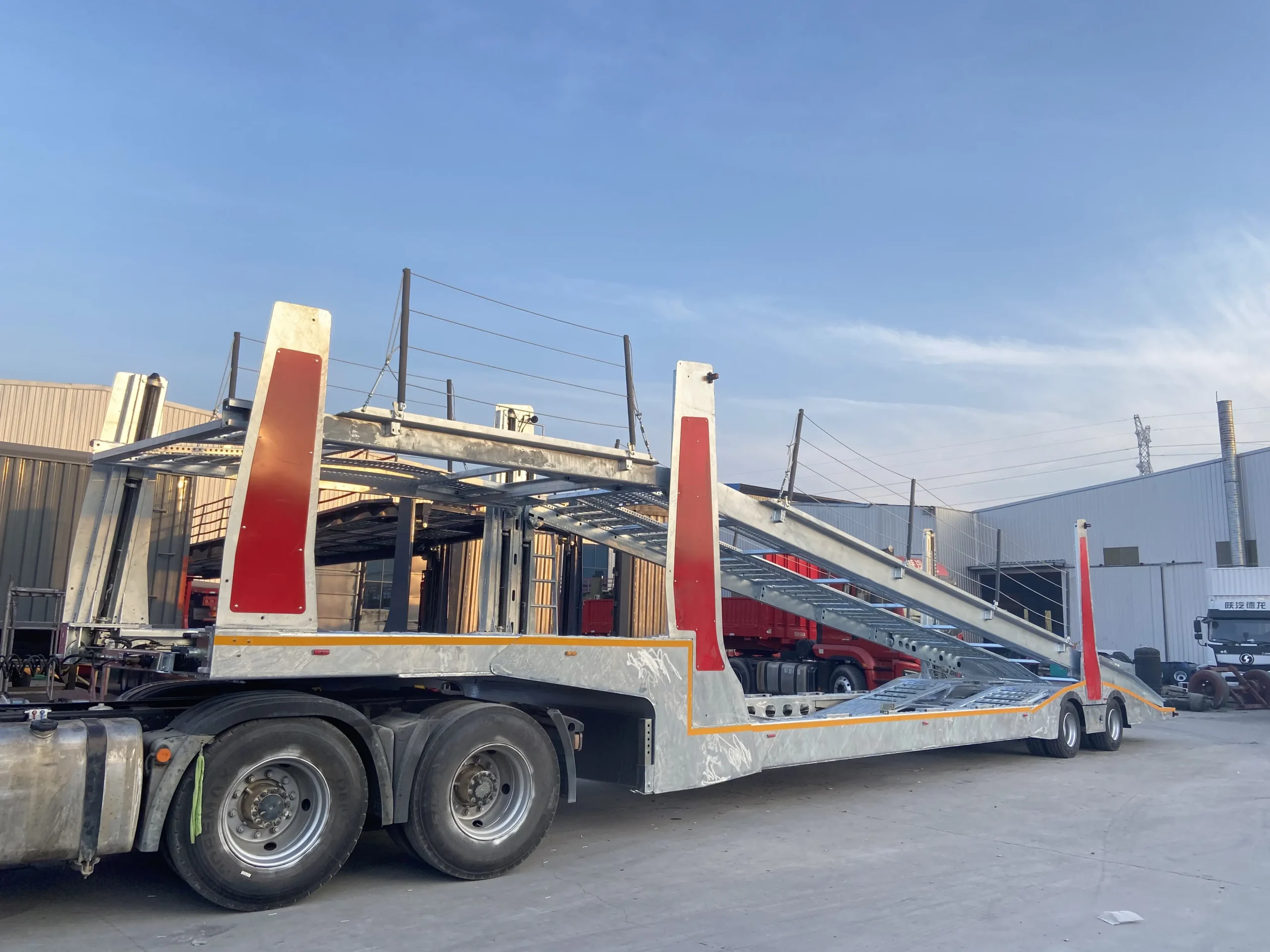 Galvanized car carrier semi-trailer coupled to a tractor
