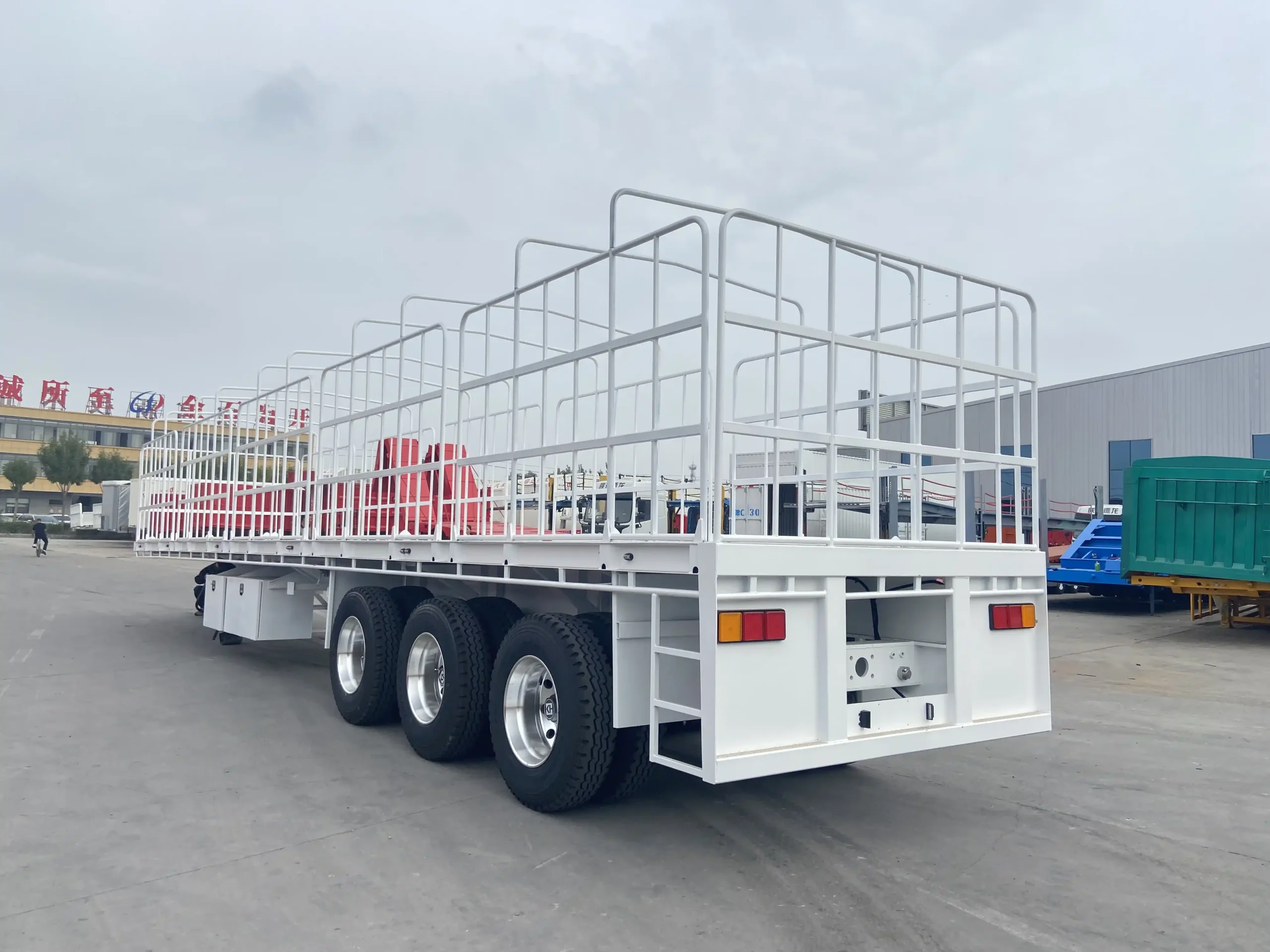 Rear side view of a tri axle flat top semi trailer