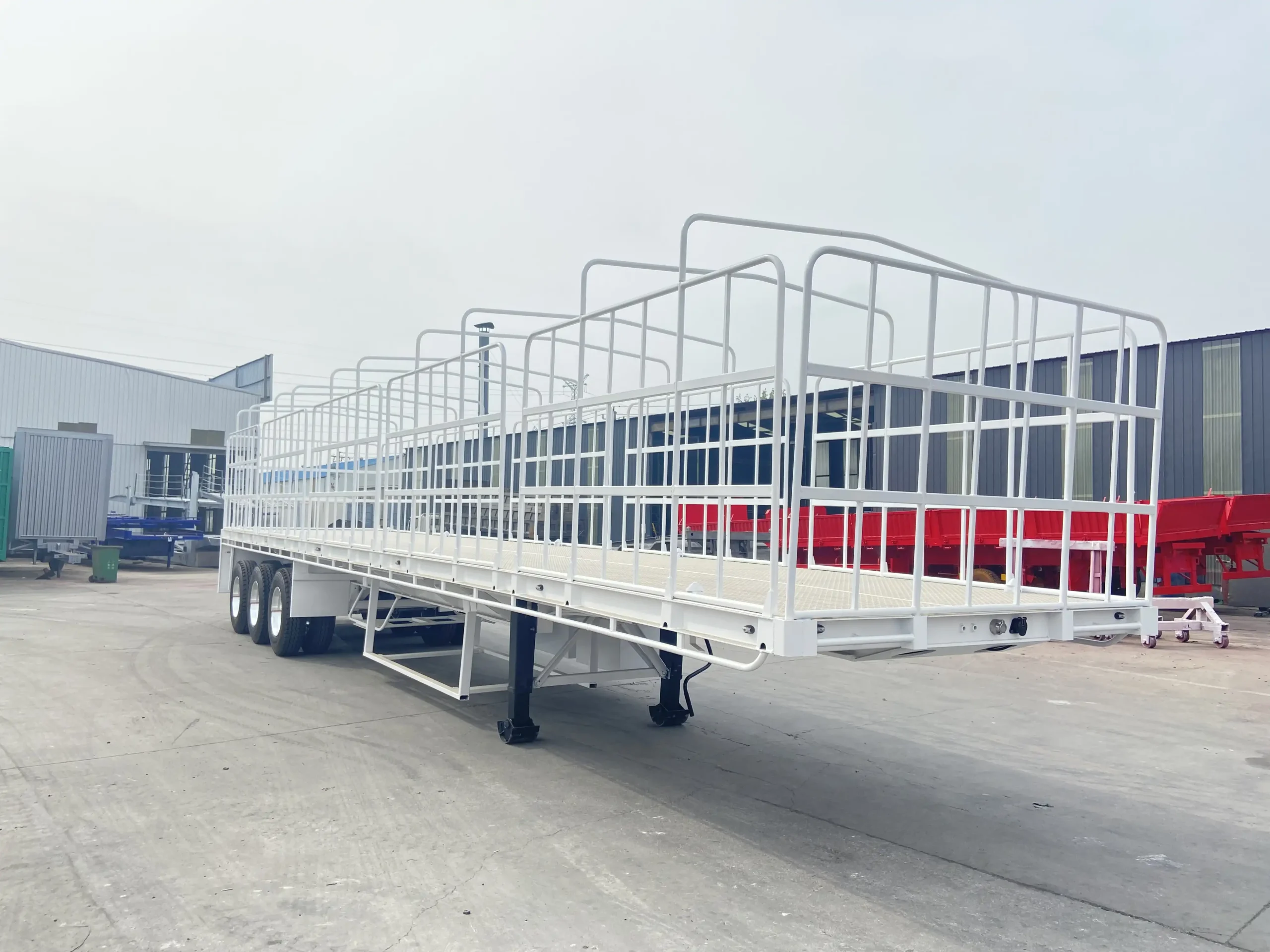 Front side view of a tri axle flat top semi trailer