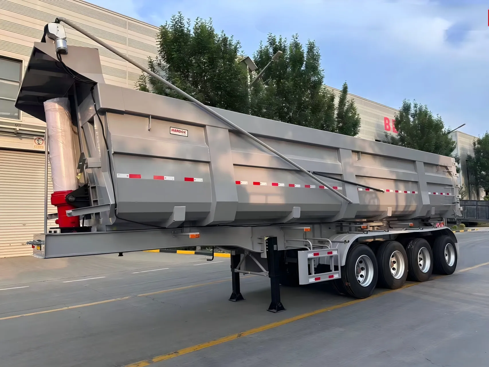 Side view of the four-axle end dump semi trailer