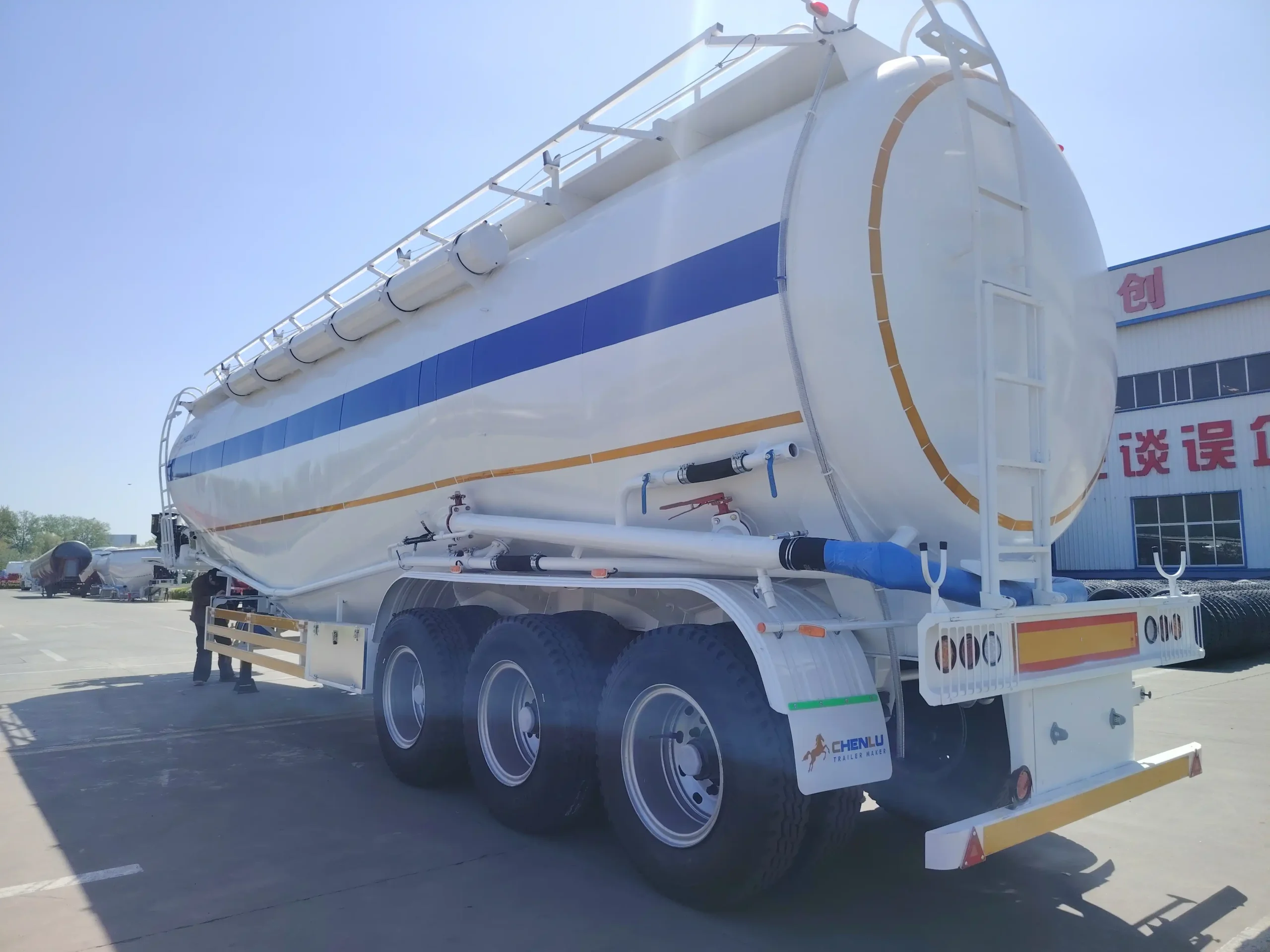 Rear three-quarter view of the white 3-axle cement tanker trailer