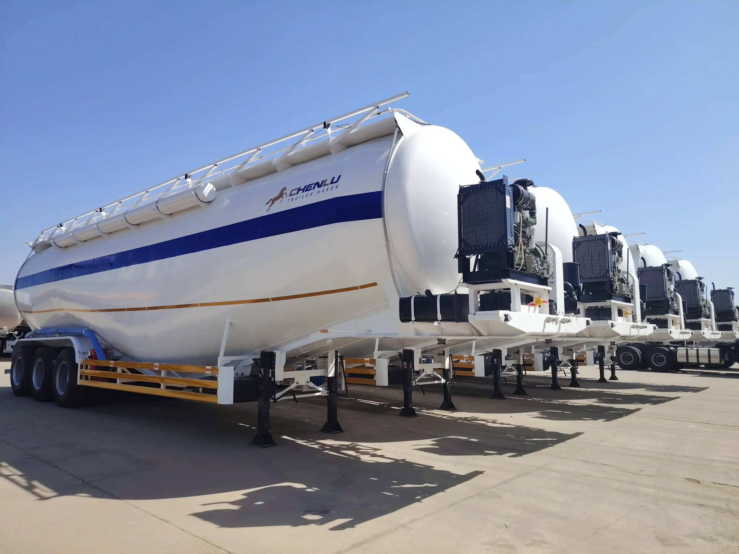 Front-mounted power and air-delivery package on a three-axle powder tanker semi-trailer