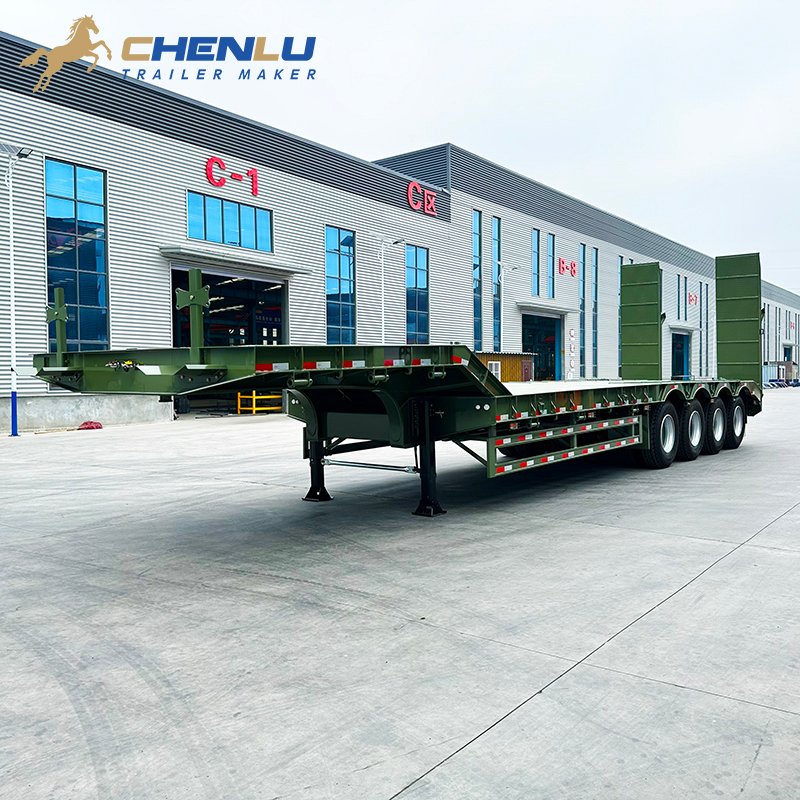Green four-axle lowbed trailer with a fixed gooseneck and upright rear ramps