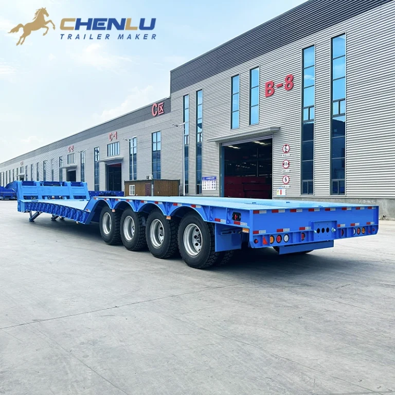 Blue lowbed semi-trailer viewed from the rear in the factory yard