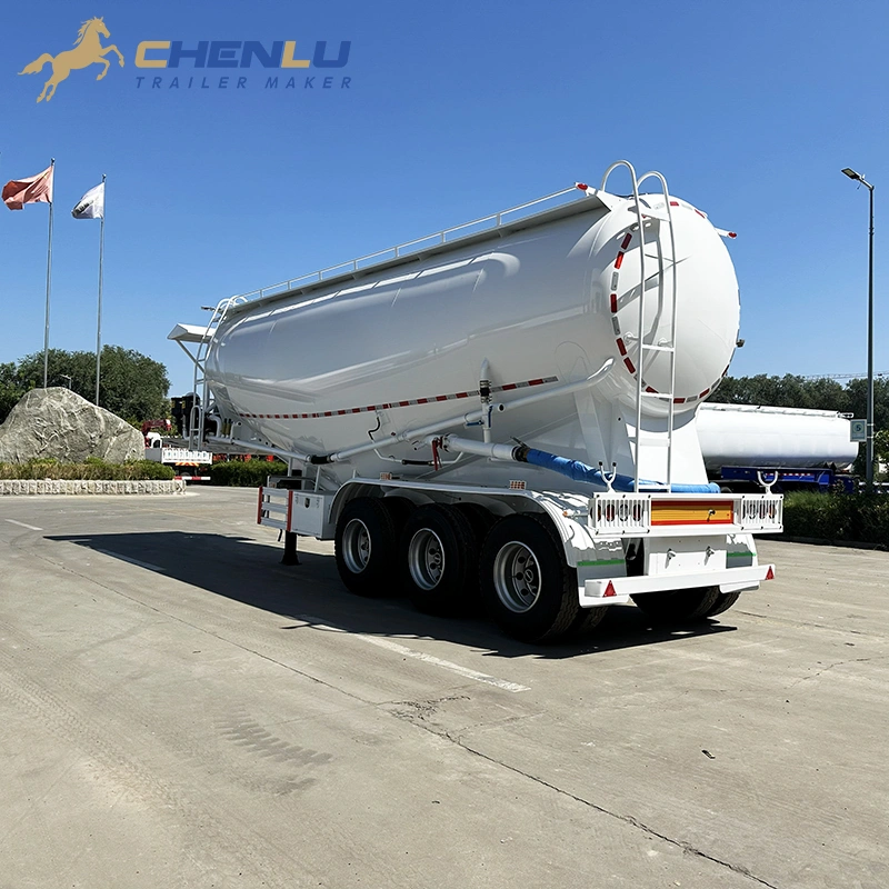 White three-axle cement tanker with a rear ladder and rounded tank end