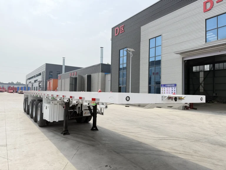 White five-axle open-deck flatbed semi-trailer