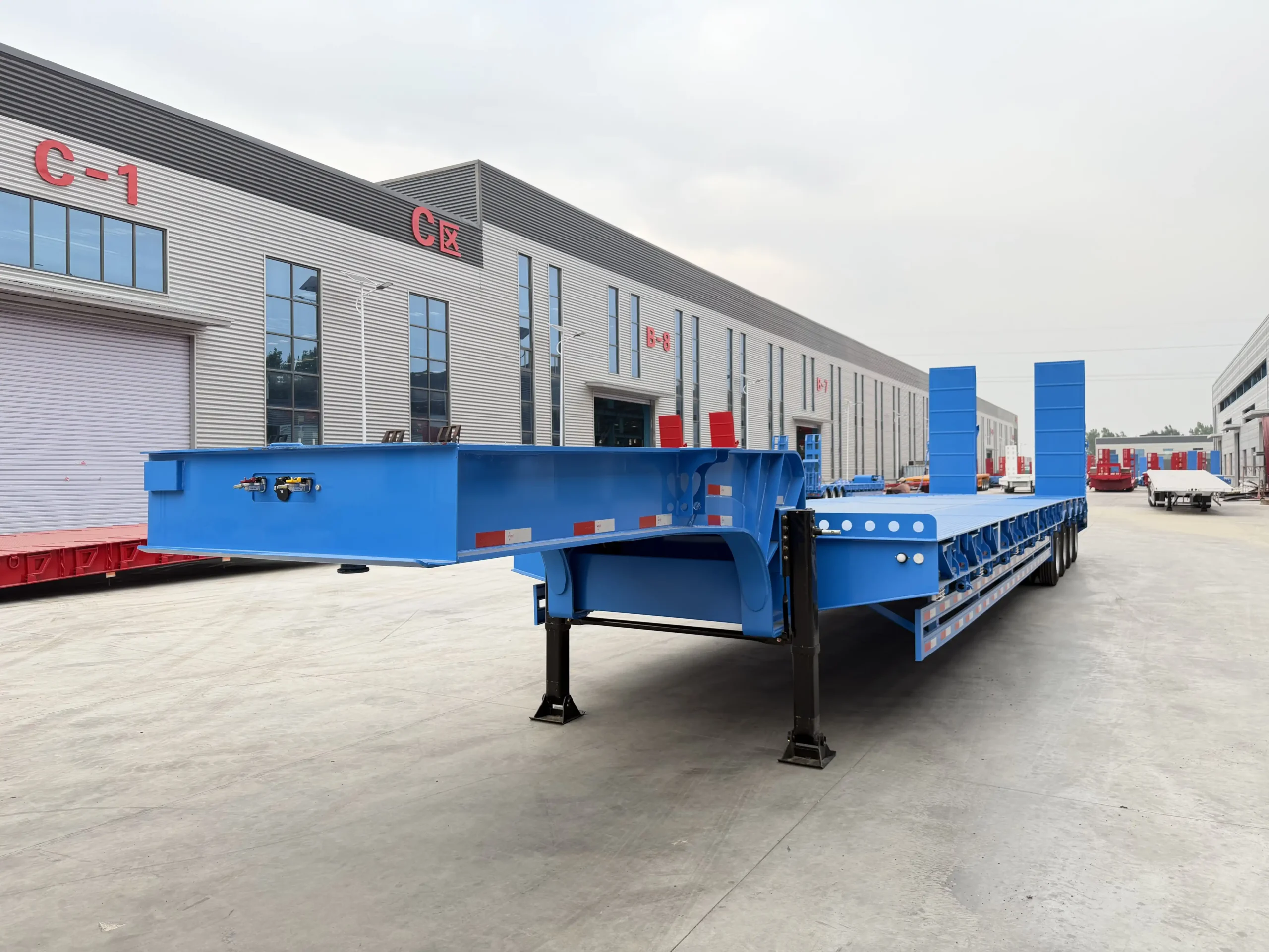 Blue 80 ton 4 axle lowbed trailer front three-quarter view