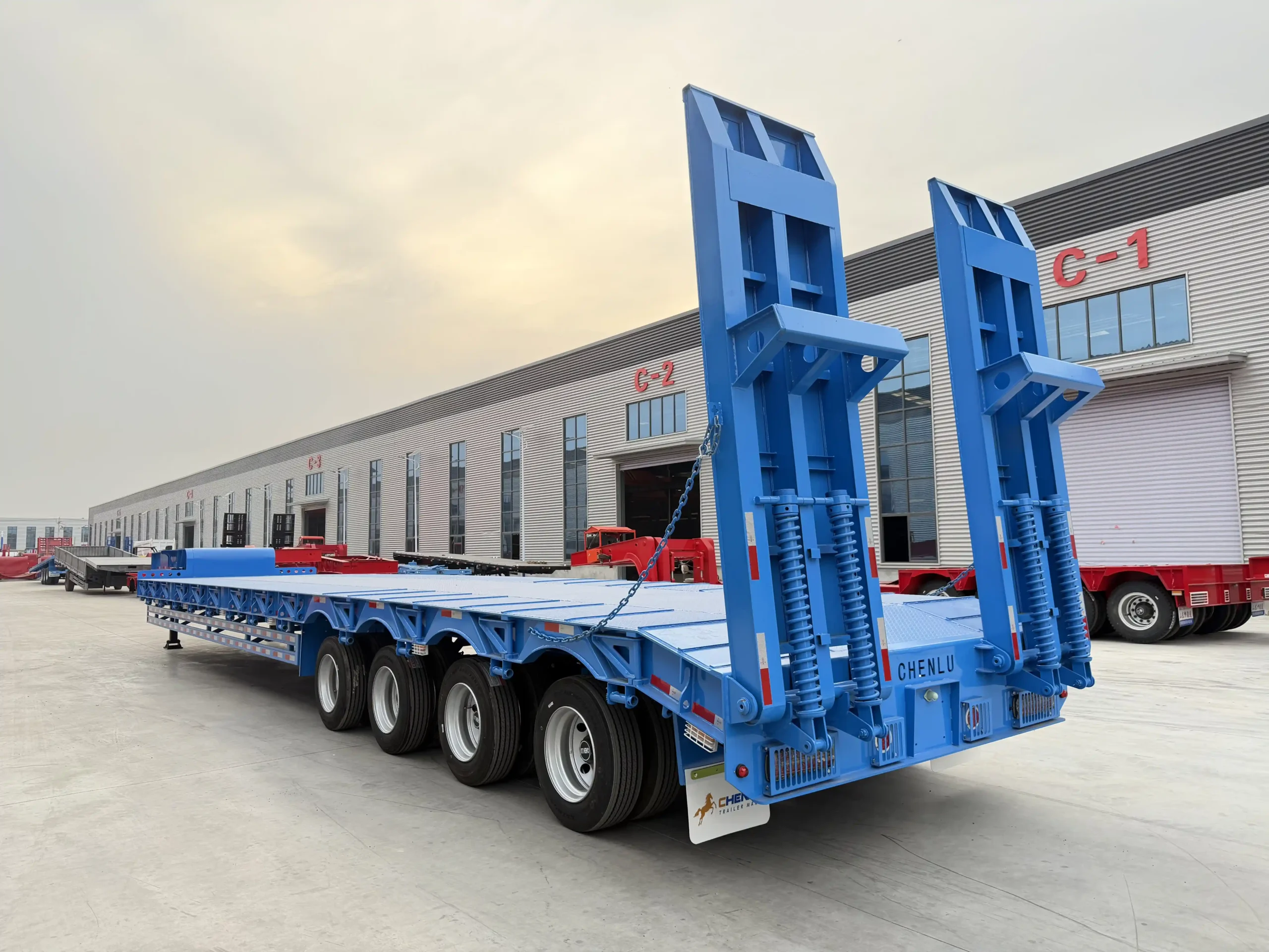 Rear three-quarter view of a blue 80 ton lowbed semi trailer