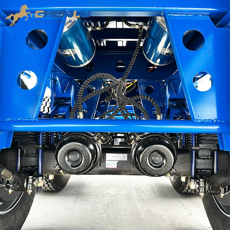 Brake chambers and air lines installed around the axle group of the blue flatbed trailer