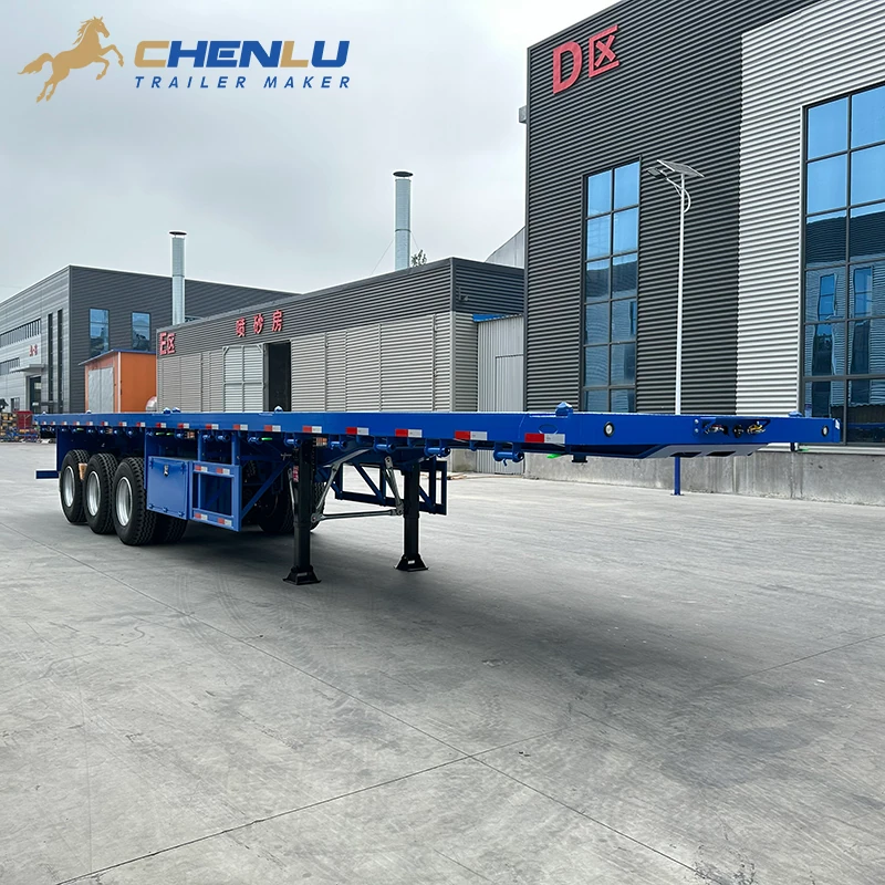 Full view of the open deck on the blue three-axle container flatbed trailer