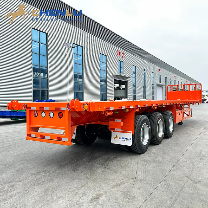 Rear three-quarter view of the orange CHENLU flatbed showing its continuous deck, open side rail and three-axle wheel group