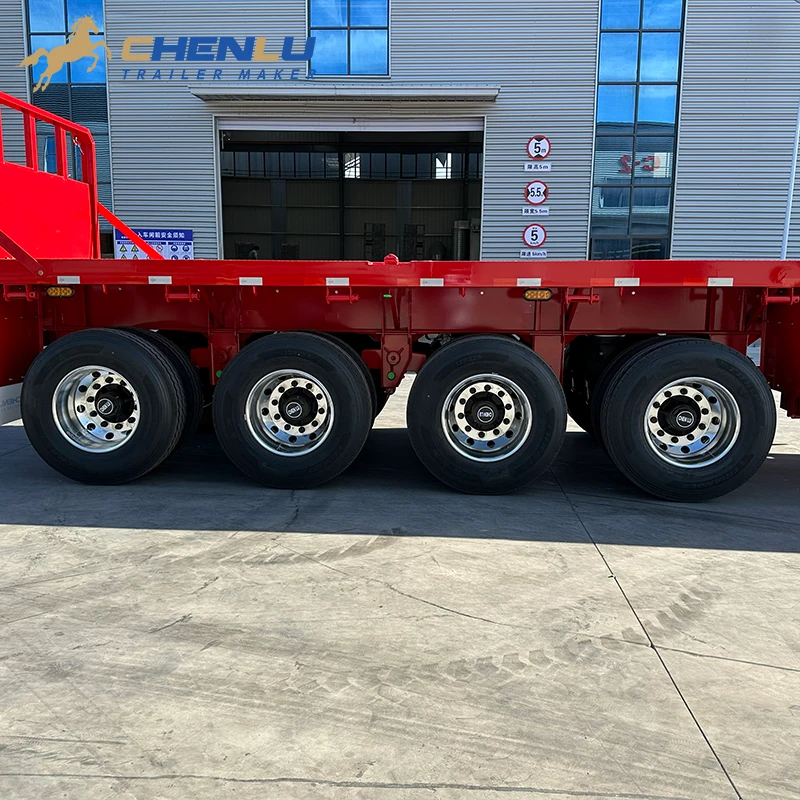 Four-axle wheel group beneath the red flatbed trailer