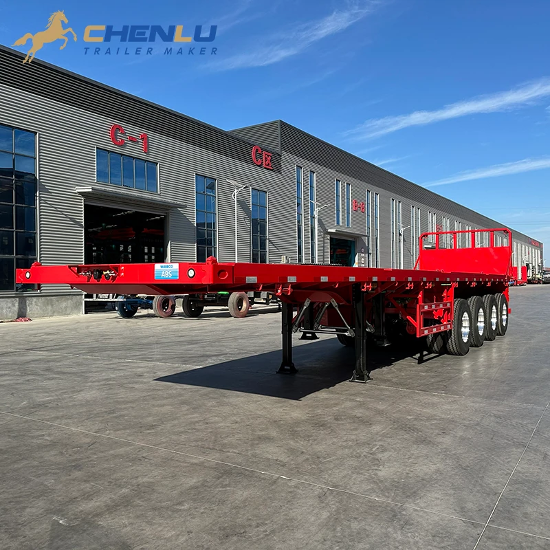 Opposite front angle of the red four-axle flatbed trailer