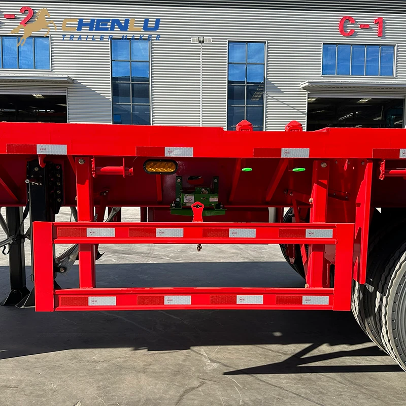 Steel side guard below the deck of the four-axle flatbed trailer