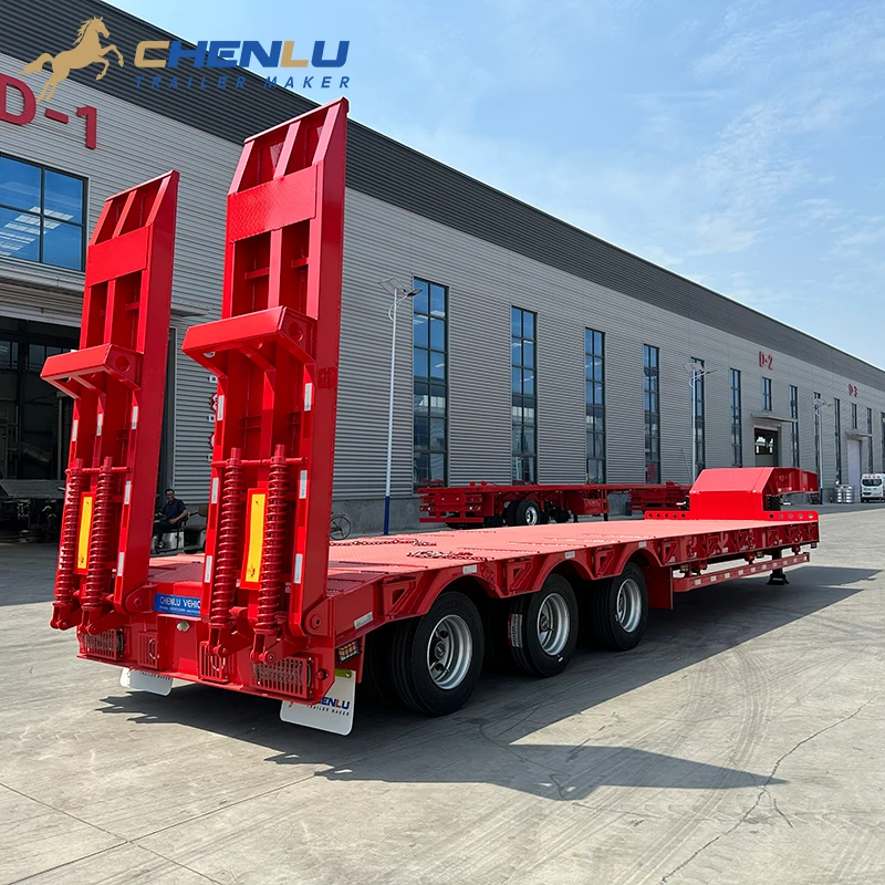 Rear three-quarter view of the red three-axle lowbed with low deck and twin loading ramps