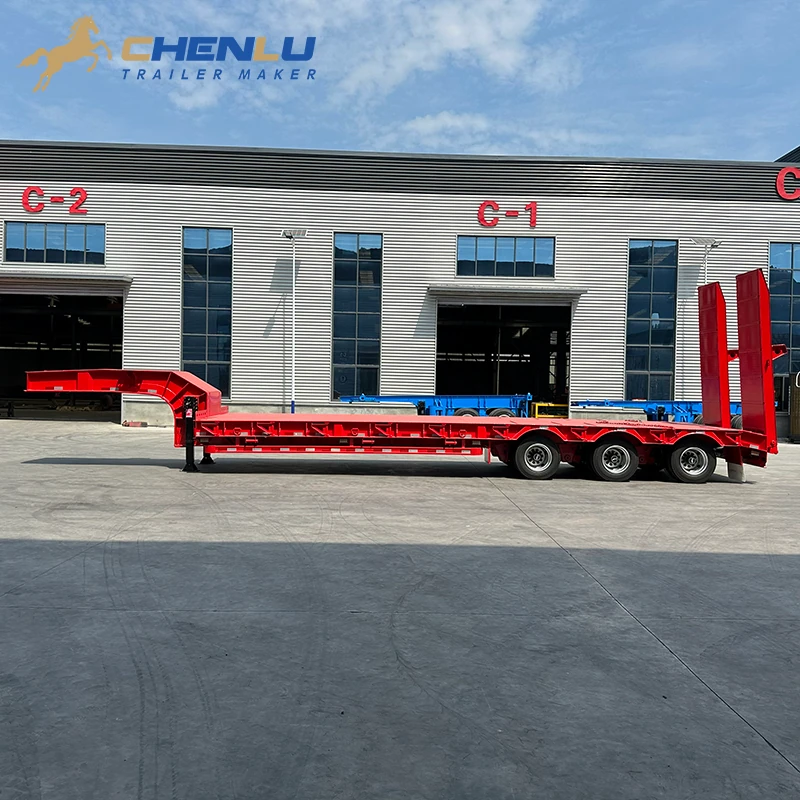 Side profile of the red three-axle lowbed, from fixed gooseneck to rear ramps