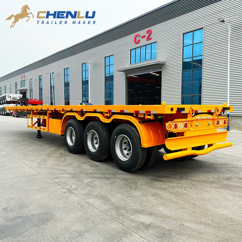 Rear three-quarter view of the yellow 60 ton flatbed semi trailer