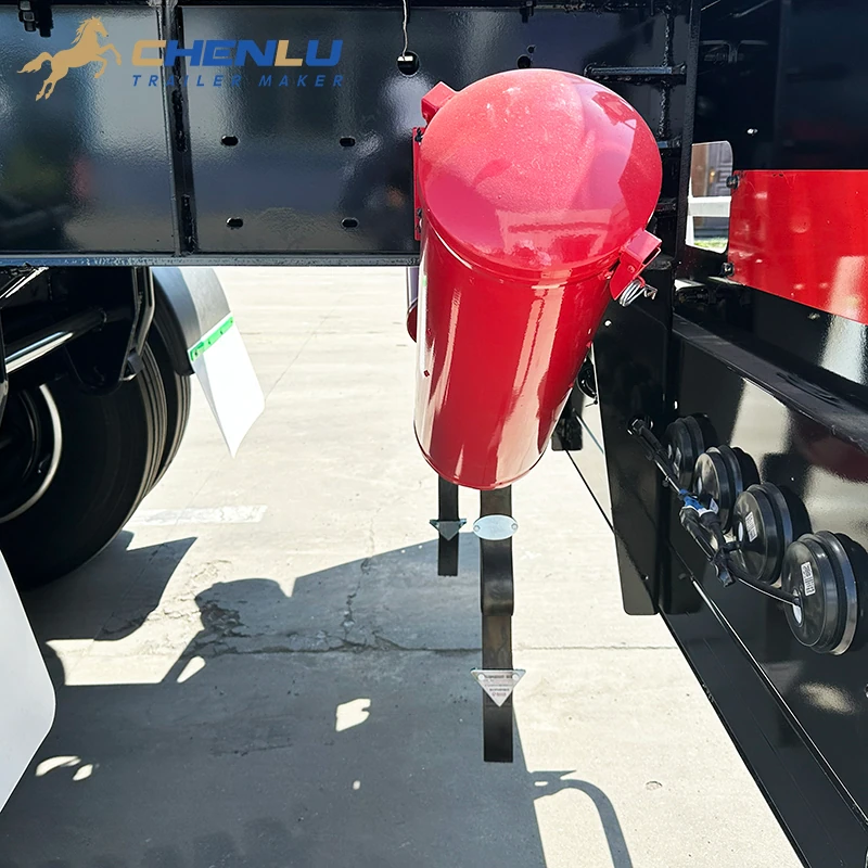 Red latched fire extinguisher holder mounted beside the tanker trailer chassis