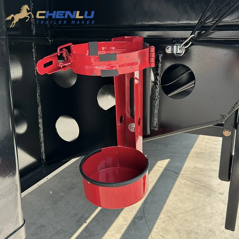 Red fire-extinguisher holder fixed to the trailer frame