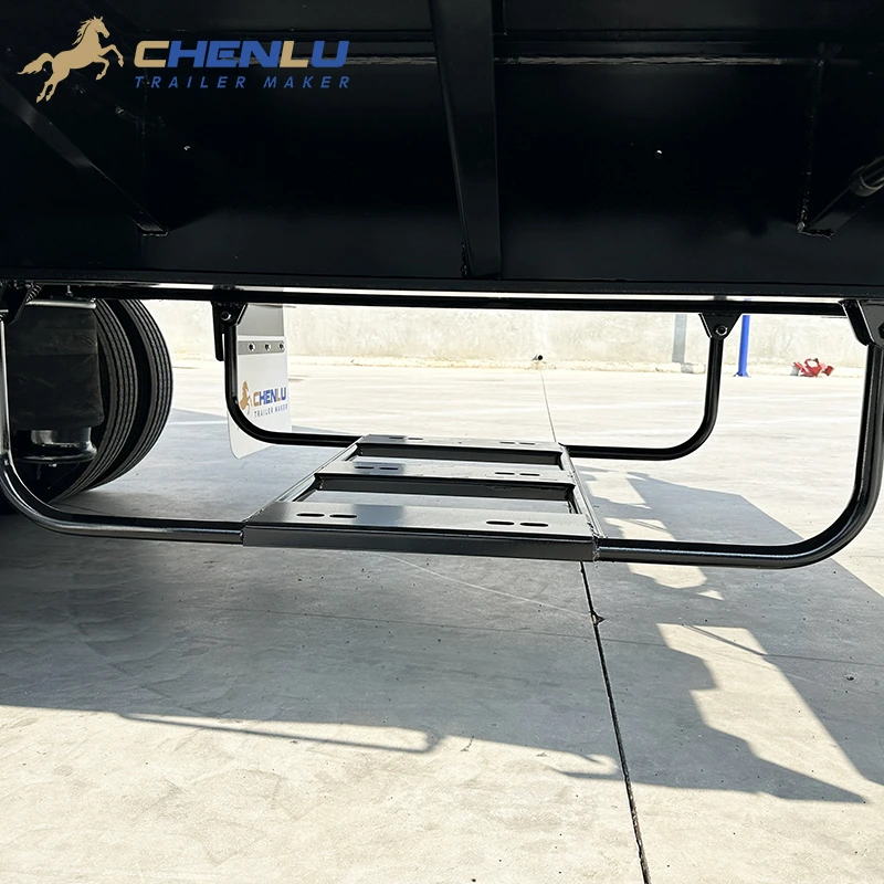 Empty spare-wheel carrier mounted beneath the curtain side trailer chassis