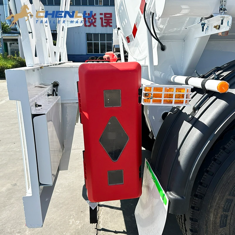 Red fire-extinguisher box mounted beside the rear wheel of the fuel tanker trailer